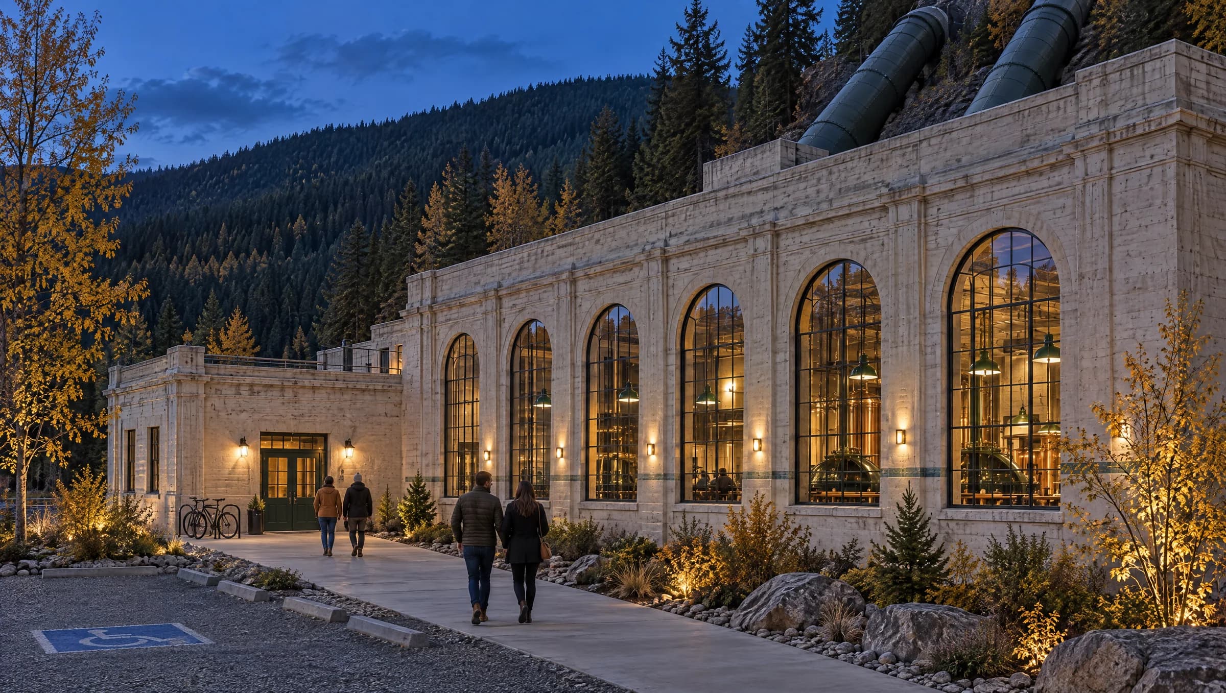 Dusk at the Breaker Room powerhouse: the path from the parking lot leads to the green entrance door, with a bike rack and an accessible parking stall beside it